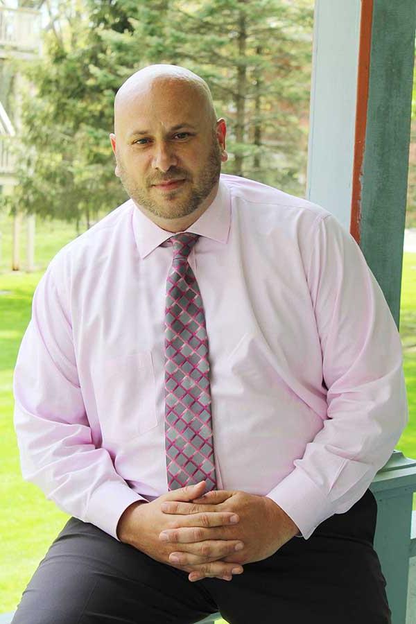 Jeremy Collins on the porch of Alumni Hall